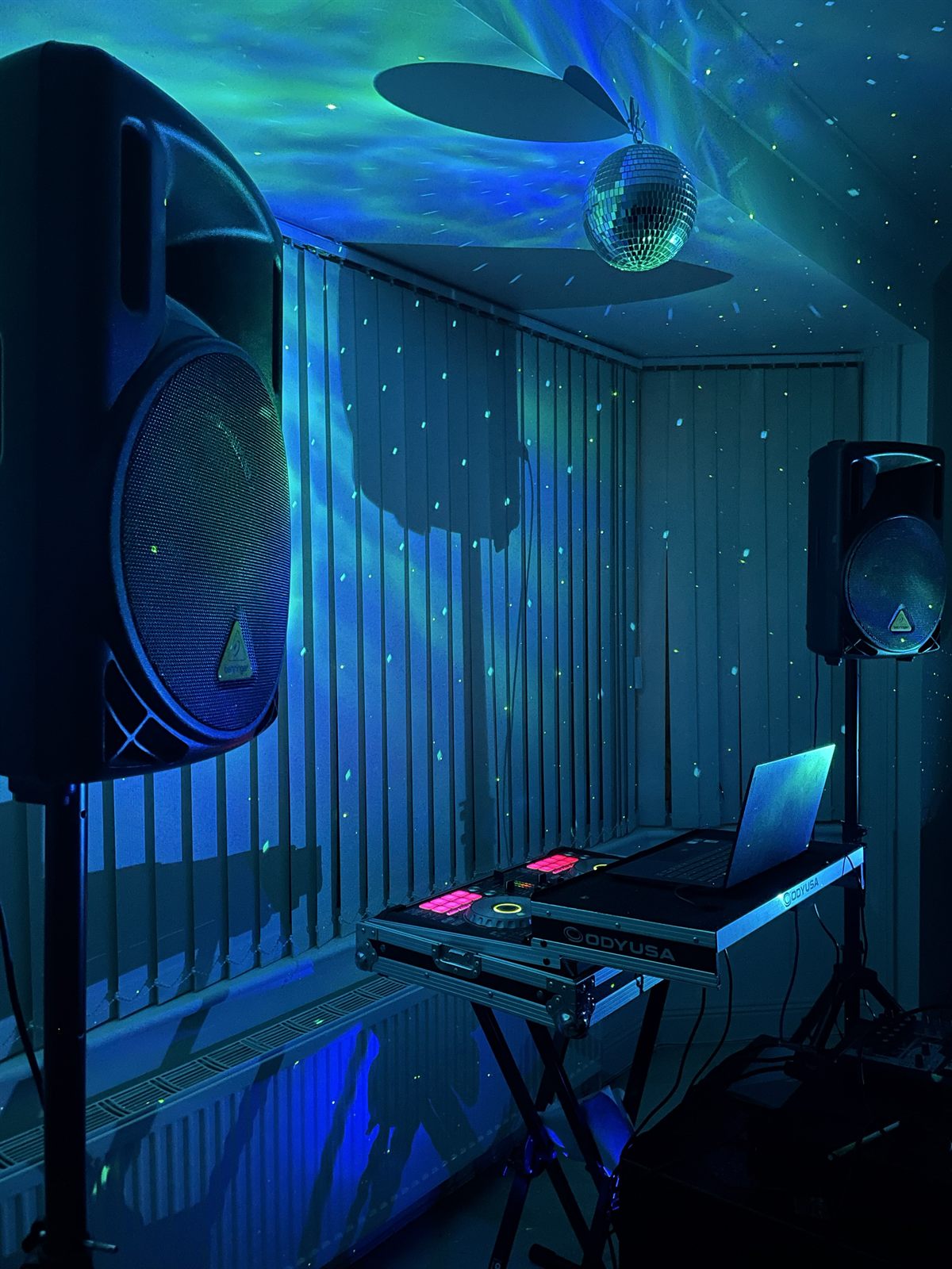 The same PA system viewed from the side, showing the full height of the speaker stands and the subwoofer and mixer below.